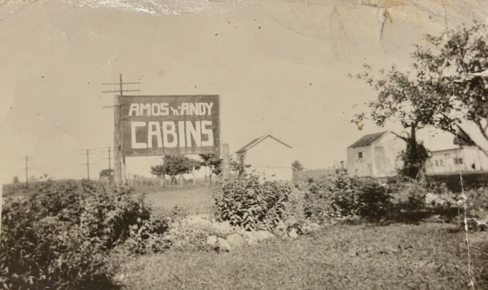 Vintage roadside sign reading "Amos 'n' Andy Cabins"