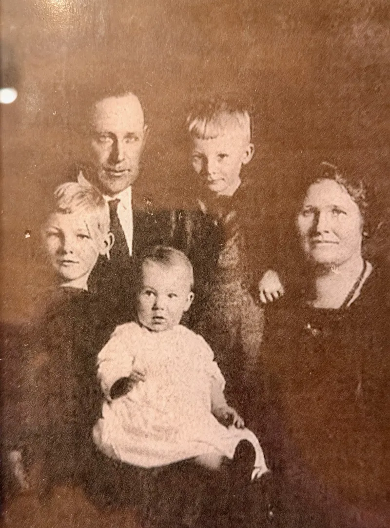 Sepia family portrait — parents and three children